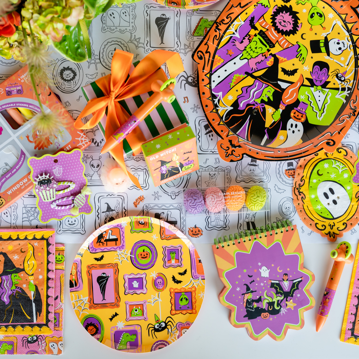 Monster Mash spread with framed-monster plates, a purple die-cut plate, crayon favors, and notepads.