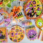 Monster Mash spread with framed-monster plates, a purple die-cut plate, crayon favors, and notepads.